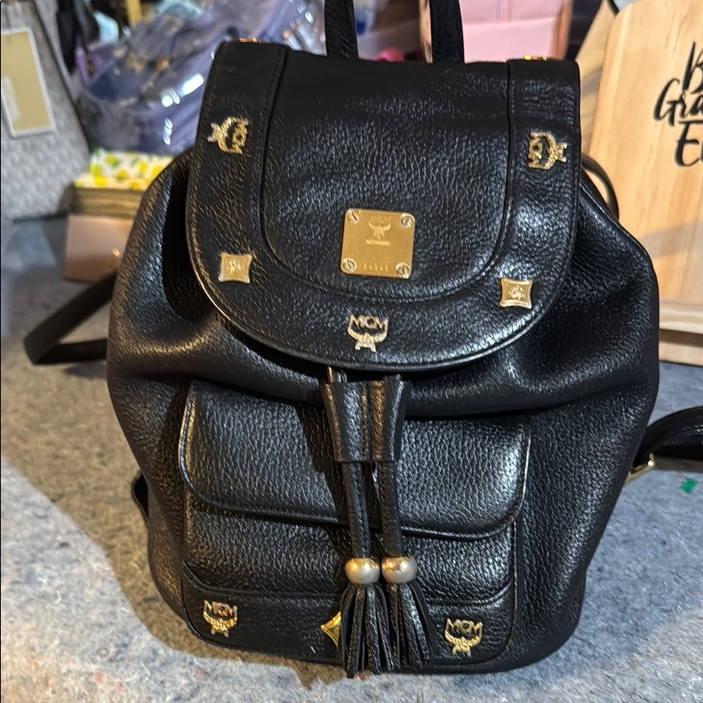 MCM Black Backpack with Gold Hardware and Structured Design